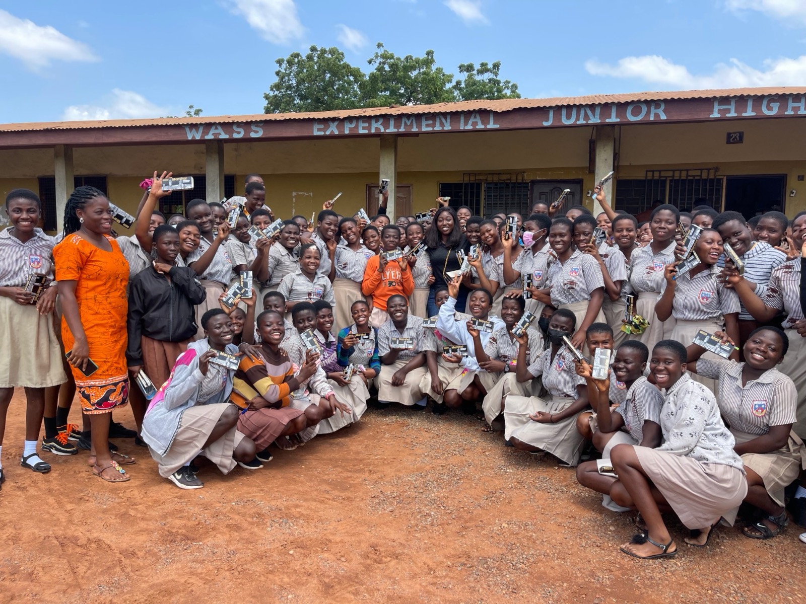 Schoolgirls holding donated supplies